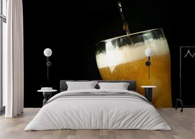 pour beer in a beer glass, tasty fresh beer in a beer grocery glass Wall mural