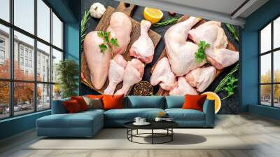 Raw chicken pieces for cooking and barbecue with breasts, legs and wings on a stone background Wall mural