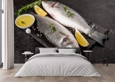 Sea bass fish with spices on a stone background Wall mural