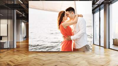 Love on the ship, couple in love hug on a yacht at sea. Wall mural