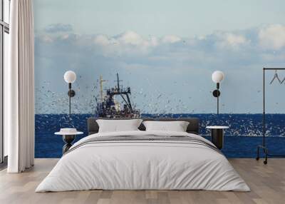 Fishing boat in the sea. Wall mural