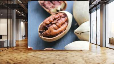 Pecan nuts on a wooden table close-up. Healthy food, healthy lifestyle, diet, vegetarianism. Wall mural