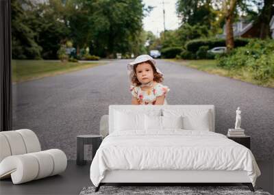 
baby sitting on the road Wall mural