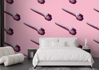 mesorollers on a pink background, pattern. hard shadows. the concept of skin care. Wall mural