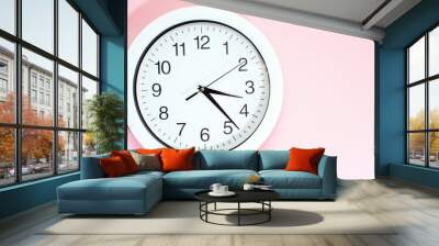 Part of a white wall clock. Close-up image of a plastic wall clock on a pink background with a copy of the space. Wall mural