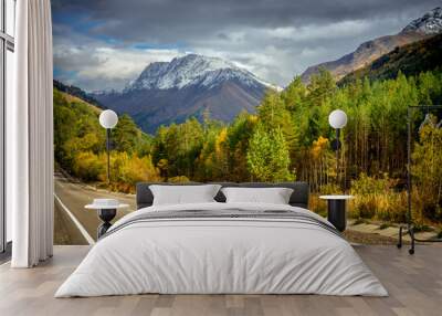 road to the gorge in the fall amid snowy peaks Wall mural