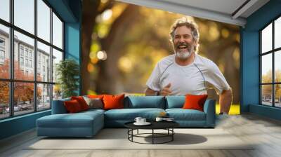 Happy older man jogging in a sunlit park with a big smile Wall mural