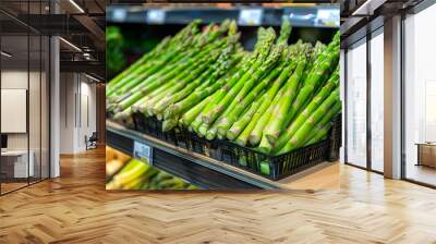 Bunch of fresh green asparagus on shelf in grocery store Wall mural