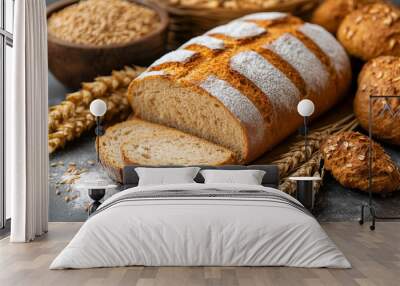 Beautiful freshly baked bread on a gray table, next to ears of wheat Wall mural