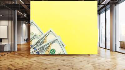 One hundred dollar bills cash lying on yellow background . Financial and business concept. Flat lay, mockup, overhead, minimalism Wall mural