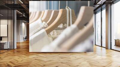 Row of different female clothes hanging on rack in hipster fashion show room in shopping mall. Trendy women wear Wall mural