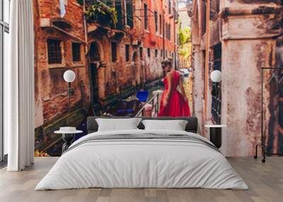  Girl in red dress at the carnival in Venice at the canal with gondolas Wall mural