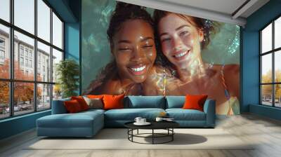 Close up fashion portrait two different races women hugging, black African American and white redhead with freckles touching their heads faces to each other on summer beach water background Wall mural