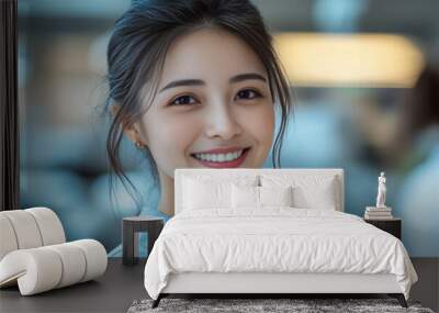 Young Female Doctor Smiling in Bright Modern Hospital Setting with Medical Colleagues in Background Wall mural