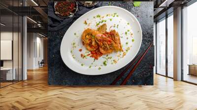 some langoustines on a plate on dark stone table, Chinese cuisine top view Wall mural