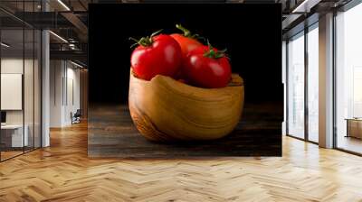 tomatoes in a wooden basket on a dark wooden background Wall mural