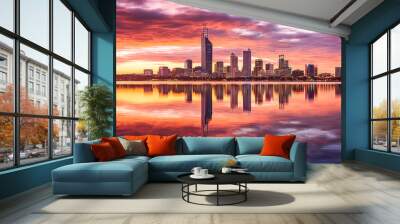 A city skyline is reflected in the water at sunset. Wall mural