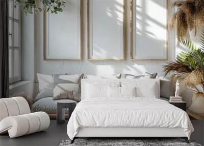 A living room with a white couch and three white picture frames on the wall Wall mural