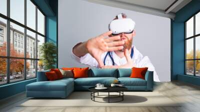 Handsome male doctor on gray background in virtual reality glasses Wall mural