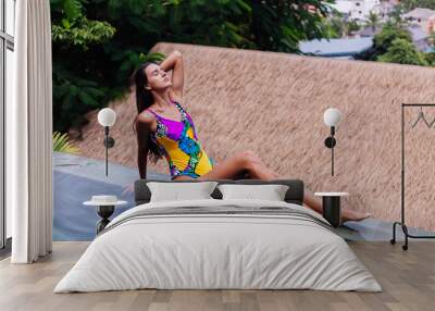 Young pretty positive happy caucasian slim woman in colorful swimsuit at luxury amazing hotel villa enjoying beautiful day on vacation in Thailand.   Wall mural