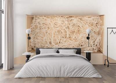 Opened box with decorative straw or shavings, top view, copy space Wall mural