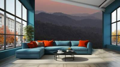 Aerial panorama of hills and orange sky in jungle at sunset. Laos Wall mural