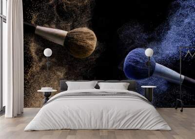 Two brushes for makeup with brown and blue make-up shadows in motion on a black background. Wall mural