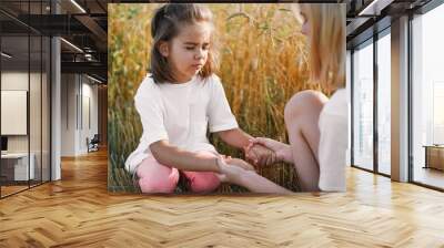 Girls praying and holding hands in a wheat field. Pray for God each other support together Wall mural