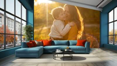 Mother and son walking in the Park and enjoying the beautiful autumn nature Wall mural