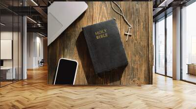 Study Bible worship online concept. Church online Sunday new normal concept. Bible, cell phone and earbuds on a wood background. Home church during quarantine coronavirus Wall mural