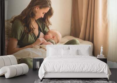 The concept of breastfeeding. Portrait of mom and breastfeeding baby.  Wall mural