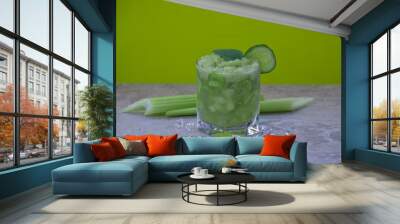 Nutritious celery cocktail for weight loss and maintaining a healthy lifestyle. In cocktail added cucumber and green leaf. There are also a few celery stalks and pieces of ice. Wall mural