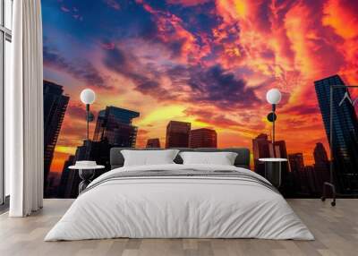 A dramatic cityscape at sunset, with towering skyscrapers silhouetted against a vibrant, fiery sky. This image is perfect for real estate and urban development businesses. Generative AI Wall mural