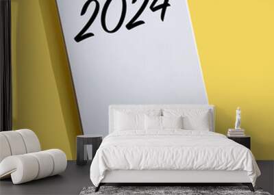 New Year 2024 written on note paper on a bright yellow background. Concept in business. Plans for the new year. Resolutions, plan, goals, action, checklist, idea concept Wall mural