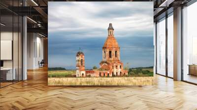 Old ruined stone christian orthodox church in a field in summer in Russia Wall mural