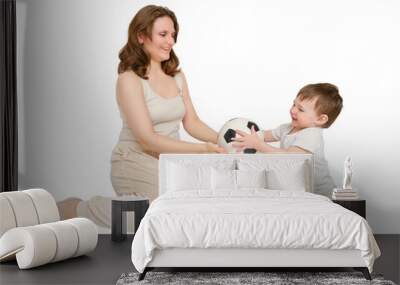 Happy baby with mother play with fotball ball on studio, isolated on white background. Kid about two years old (one year nine months) Wall mural