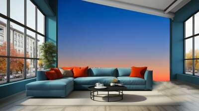 Orange and blue sunset sky gradient, copy space background. Red evening sky without clouds Wall mural