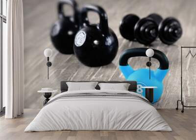 Kettlebells and dumbbells are sports fitness equipment. Fitness training lifestyle and healthy lifestyle concept. Wall mural