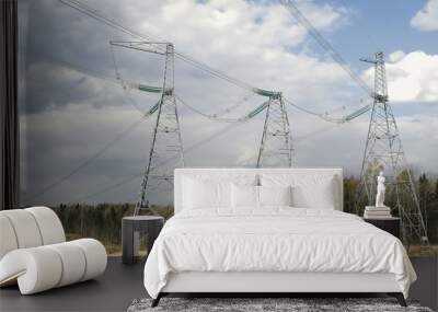 Pylons of high-voltage power lines and a blue sky with clouds. Wall mural