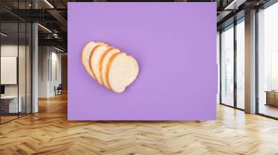 Sliced white bread on a purple background. Wall mural