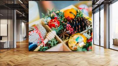 Close up of christmas wooden gift box with christmas toys, honey, pice cone, branch and star anise Wall mural