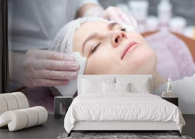 Beautiful woman with a facial mask at a beauty salon Wall mural