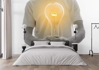 man holding a light bulb - new idea concept Wall mural