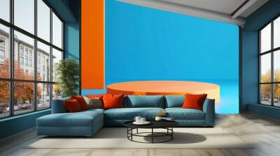 Bright orange circular podium against a vibrant blue background in a minimalist setting Wall mural