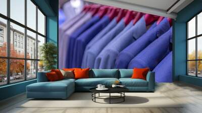 A collection of men's jackets on a hanger in the store. Close-up. Wall mural