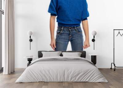 Cute teen girl in blue sweater and jeans standing, full length. Isolated on a white background. Vertical. Wall mural