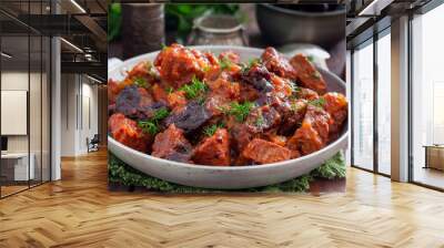 Beef with prunes in tomato sauce in a pan, horizontal Wall mural