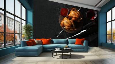 Grilled quail on a skewer with red wine on a black background. Baked chicken gherkins. The view from the top. Copy space Wall mural