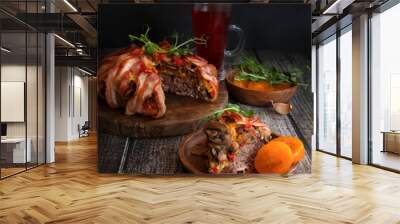 Minced meat baked in bacon. Meat pie with bacon on a dark wooden background. Wall mural