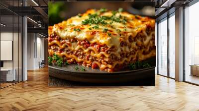 A plate of lasagna with cheese and meat. The dish is served on a black plate Wall mural